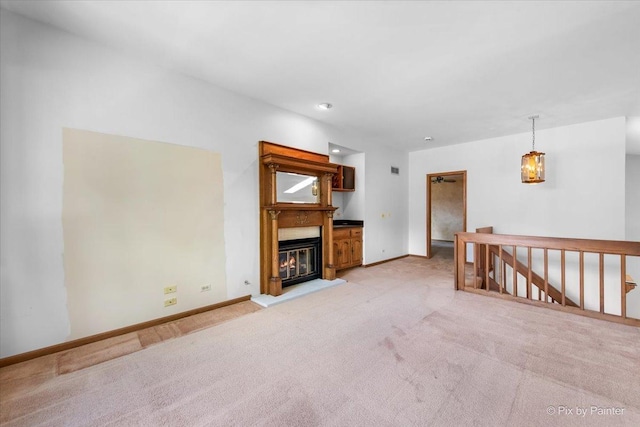 81 Castle Rock Ln, Bloomingdale, IL 60108 - unfurnished living room featuring light carpet and a glass covered fireplace