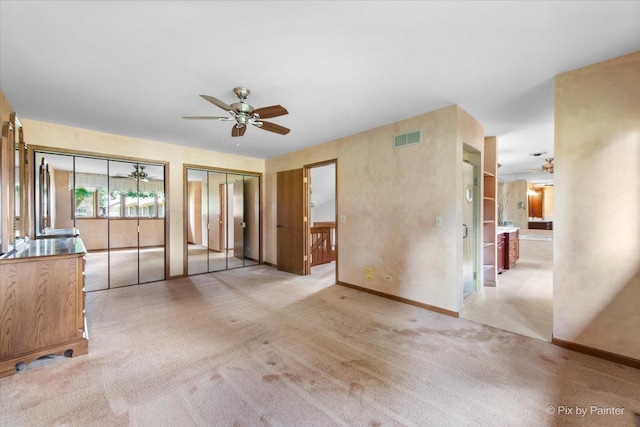 81 Castle Rock Ln, Bloomingdale, IL 60108 - unfurnished living room with ceiling fan and light carpet