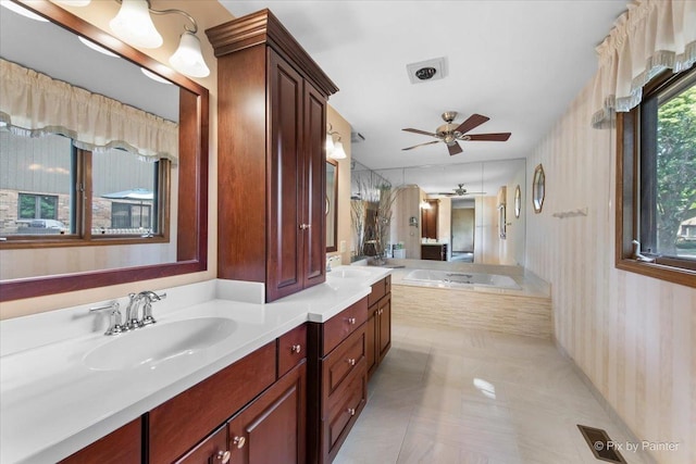 81 Castle Rock Ln, Bloomingdale, IL 60108 - bathroom with wallpapered walls, a ceiling fan, double vanity, a bath, and tile patterned floors