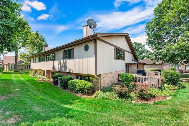 81 Castle Rock Ln, Bloomingdale, IL 60108 - view of side of home with a chimney, brick siding, and a lawn