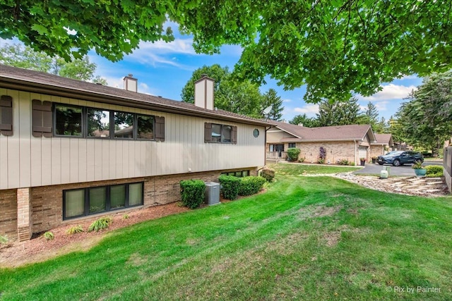 81 Castle Rock Ln, Bloomingdale, IL 60108 - view of front of home featuring a chimney, a front yard, and brick siding