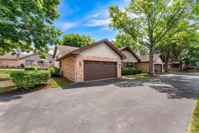 81 Castle Rock Ln, Bloomingdale, IL 60108 - ranch-style house with brick siding, a garage, and asphalt driveway