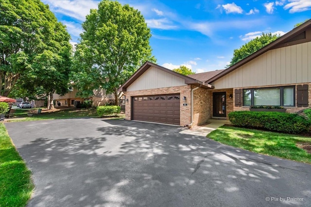 81 Castle Rock Ln, Bloomingdale, IL 60108 - view of front of property with brick siding, an attached garage, and driveway