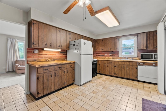9160 S 88th Ct, Hickory Hills, IL 60457 - kitchen featuring white appliances, light countertops, healthy amount of natural light, and a ceiling fan