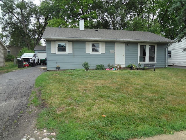 2114 Tepee Ave, Carpentersville, IL 60110 - view of front of home featuring a chimney, a front lawn, and a shingled roof