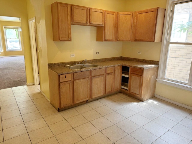663 W 117th Pl, Chicago, IL 60628 - kitchen with light tile patterned flooring, dark countertops, and brown cabinets