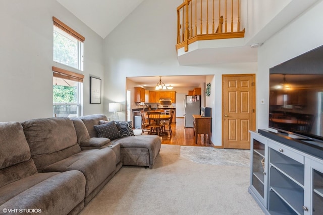 4705 Peacock Ln, Plainfield, IL 60586 - living room with high vaulted ceiling, a chandelier, and light wood-style floors