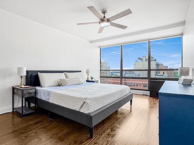 3150 N Sheridan Rd Unit 10C, Chicago, IL 60657 - bedroom featuring a city view, wood finished floors, expansive windows, and a ceiling fan