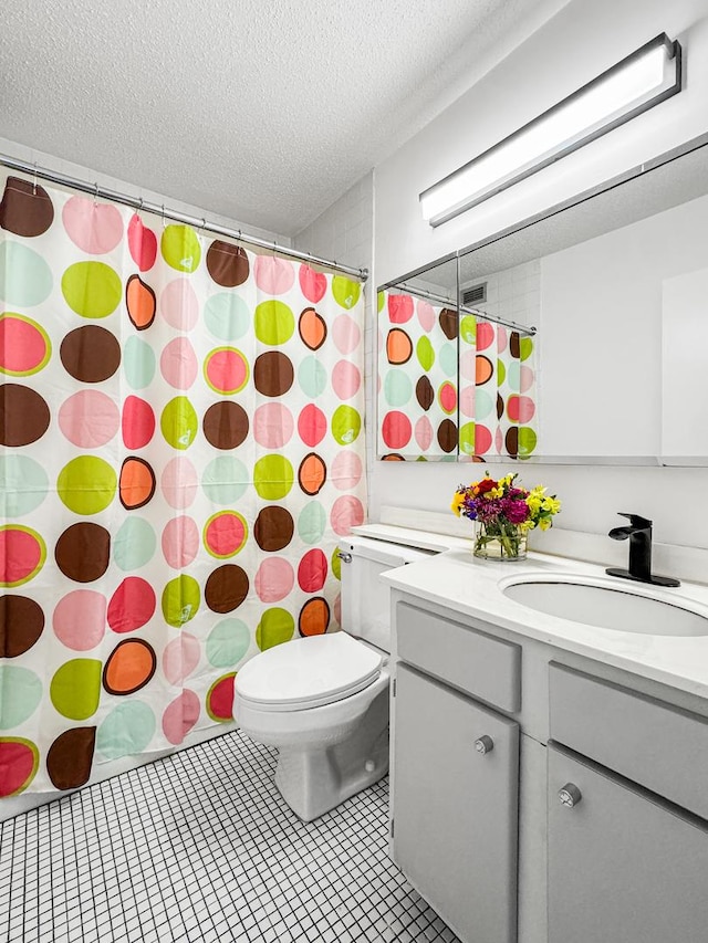 3150 N Sheridan Rd Unit 10C, Chicago, IL 60657 - bathroom with a textured ceiling, vanity, tile patterned floors, and a shower with curtain