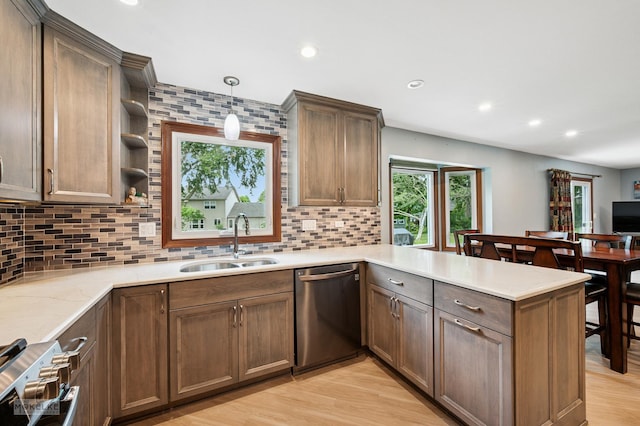 2430 Lakeside Dr, Aurora, IL 60504 - kitchen with stainless steel dishwasher, a peninsula, backsplash, open shelves, and stove