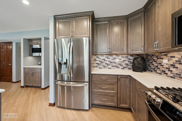 2430 Lakeside Dr, Aurora, IL 60504 - kitchen with stainless steel appliances, tasteful backsplash, light wood-style floors, dark brown cabinetry, and recessed lighting