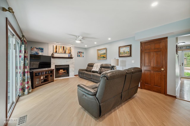 2430 Lakeside Dr, Aurora, IL 60504 - living area featuring light wood-style floors, ceiling fan, a fireplace, and recessed lighting