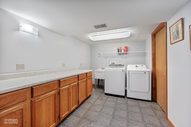 2430 Lakeside Dr, Aurora, IL 60504 - laundry room featuring independent washer and dryer, cabinet space, and light flooring