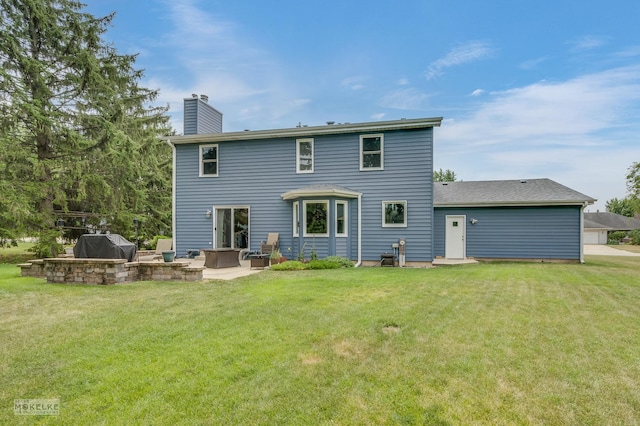 2430 Lakeside Dr, Aurora, IL 60504 - rear view of house featuring a chimney, a yard, and a patio