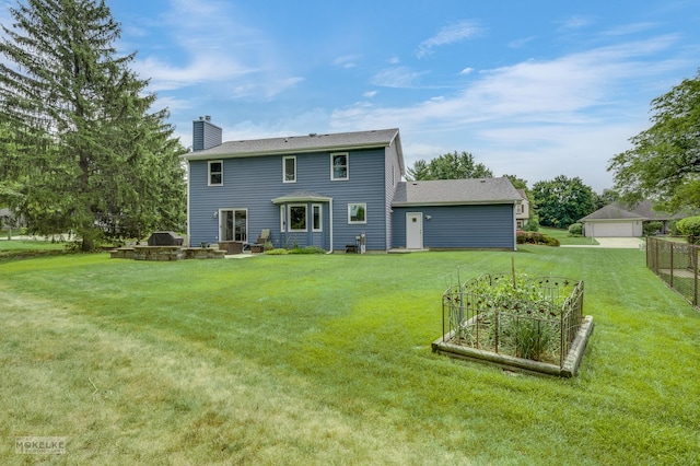 2430 Lakeside Dr, Aurora, IL 60504 - rear view of property with a vegetable garden and a chimney