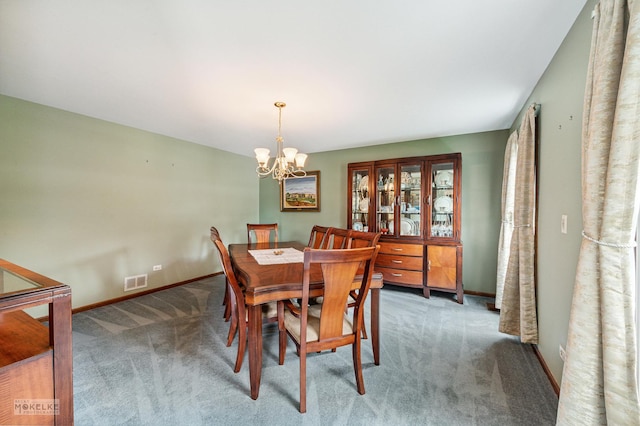 2430 Lakeside Dr, Aurora, IL 60504 - carpeted dining area with a chandelier and baseboards