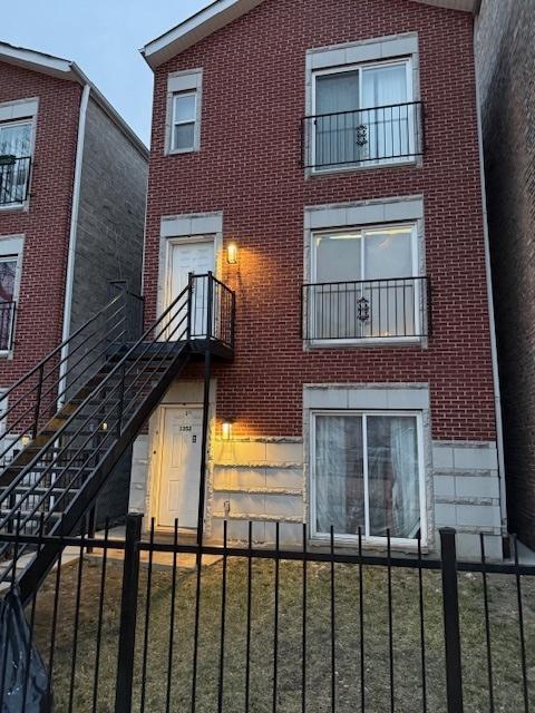 1352 S Kedvale Ave, Chicago, IL 60623 - back of house with brick siding and a fenced front yard
