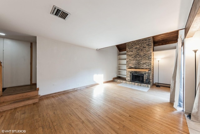 3341 Beacon St Unit 32, North Chicago, IL 60064 - unfurnished living room featuring light wood-type flooring and a fireplace