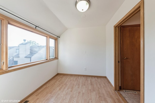 3341 Beacon St Unit 32, North Chicago, IL 60064 - spare room featuring vaulted ceiling and light wood-style flooring