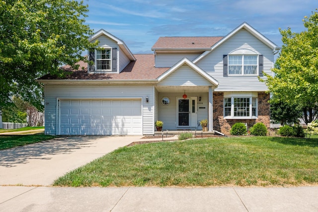 3308 Cumbria Dr, Bloomington, IL 61704 - view of front of home featuring a front yard, driveway, and brick siding