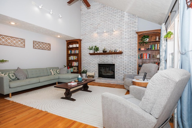 3308 Cumbria Dr, Bloomington, IL 61704 - living area with wood finished floors, a fireplace, high vaulted ceiling, and ceiling fan