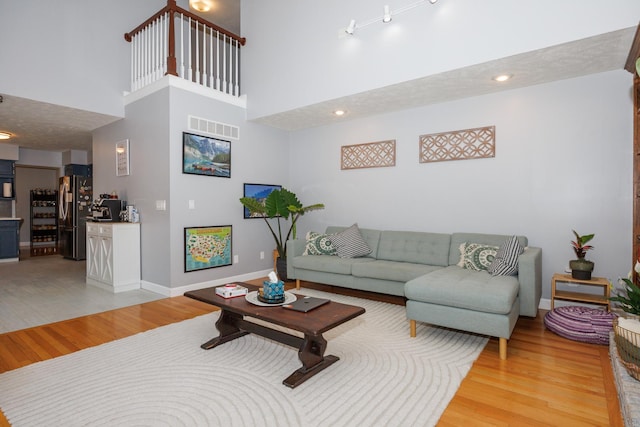 3308 Cumbria Dr, Bloomington, IL 61704 - living room featuring light wood finished floors and a towering ceiling