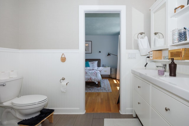 3308 Cumbria Dr, Bloomington, IL 61704 - bathroom featuring wainscoting, vanity, wood finished floors, and ensuite bath