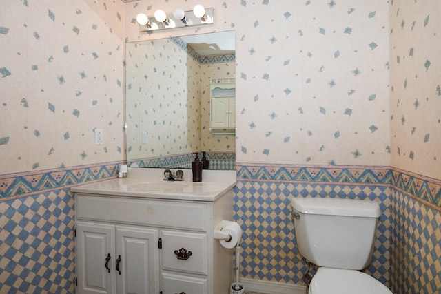 3308 Cumbria Dr, Bloomington, IL 61704 - half bathroom with wallpapered walls, vanity, wainscoting, and tile walls