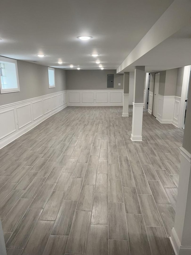 10200 S Union Ave, Chicago, IL 60628 - below grade area with a decorative wall, light wood-type flooring, and wainscoting