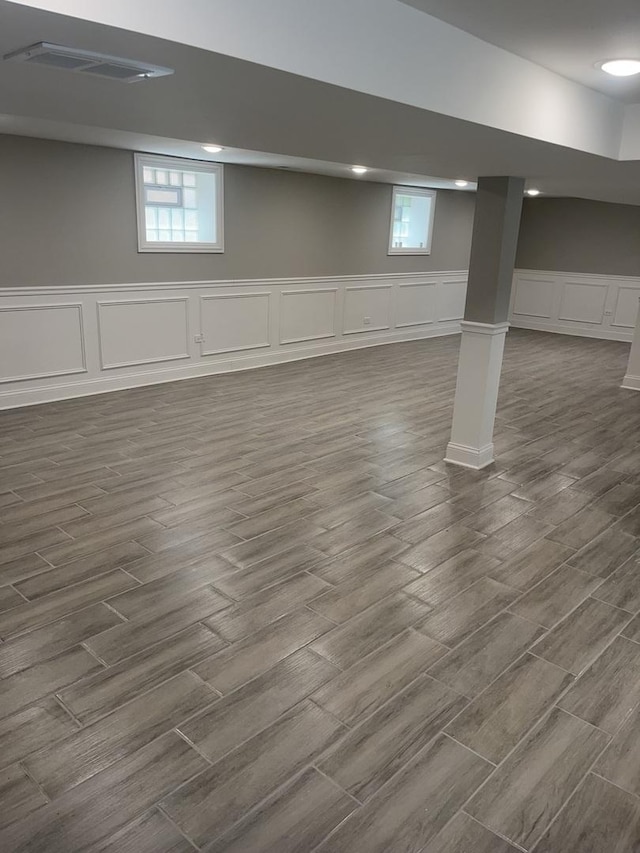 10200 S Union Ave, Chicago, IL 60628 - basement featuring a decorative wall, dark wood-style floors, healthy amount of natural light, and a wainscoted wall