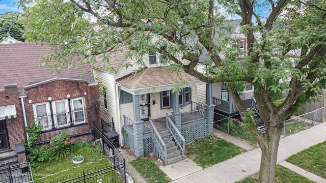 7207 S Winchester Ave, Chicago, IL 60636 - view of front of house with covered porch, a shingled roof, and brick siding