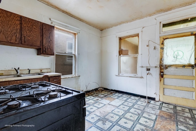 7207 S Winchester Ave, Chicago, IL 60636 - kitchen featuring black range with gas stovetop, light flooring, and light countertops