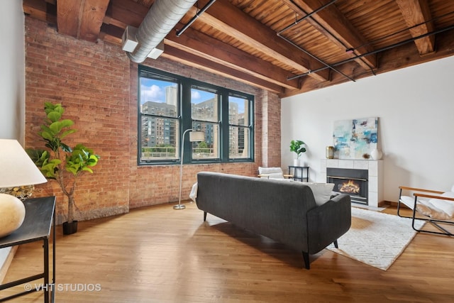 732 S Financial Pl Unit 202, Chicago, IL 60605 - living area with a wooden ceiling with exposed beams, brick wall, wood finished floors, and a fireplace