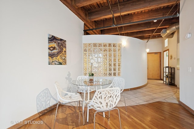 732 S Financial Pl Unit 202, Chicago, IL 60605 - dining space with a wood ceiling with exposed beams, tile patterned flooring, and a high ceiling