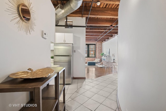 732 S Financial Pl Unit 202, Chicago, IL 60605 - kitchen with freestanding refrigerator, light tile patterned flooring, and white cabinets