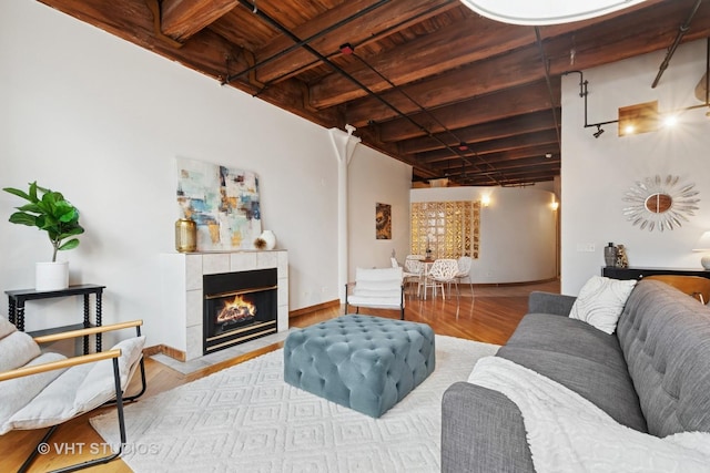 732 S Financial Pl Unit 202, Chicago, IL 60605 - living room with a wooden ceiling with exposed beams, wood finished floors, and a tiled fireplace