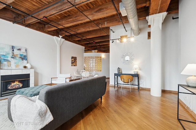 732 S Financial Pl Unit 202, Chicago, IL 60605 - living room featuring wood finished floors, a tile fireplace, and a wood ceiling with exposed beams