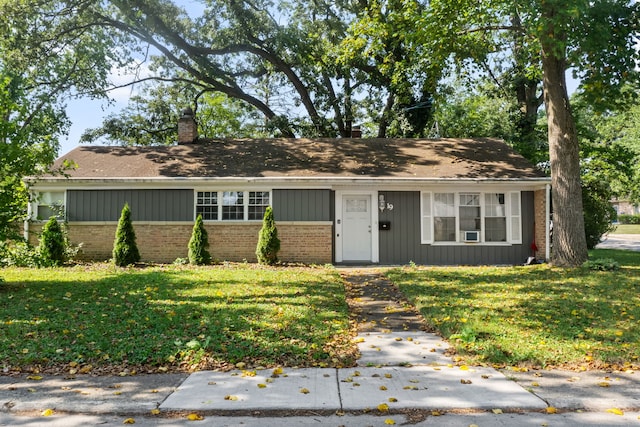 19 Apple Ln, Park Forest, IL 60466 - view of front facade with brick siding, a front yard, a chimney, and a shingled roof