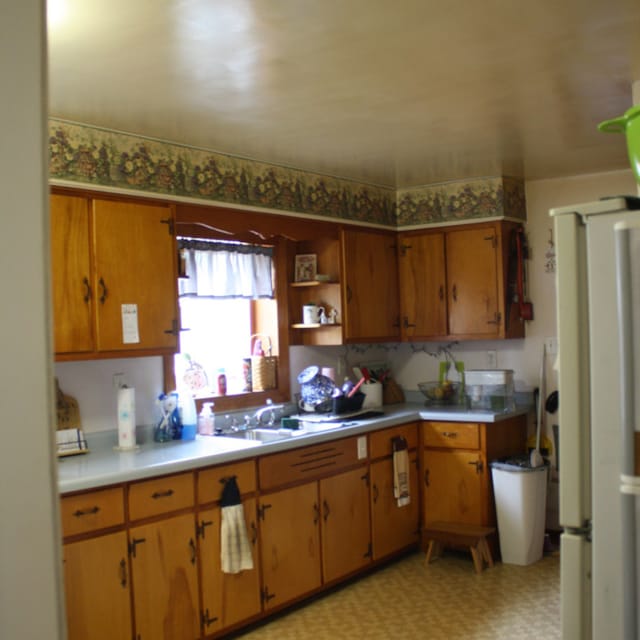 1 Elm Dr, Bethany, IL 61914 - kitchen featuring light countertops, freestanding refrigerator, light flooring, and brown cabinetry