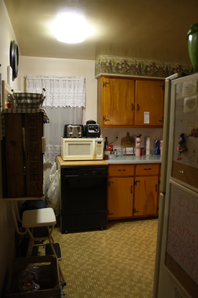 1 Elm Dr, Bethany, IL 61914 - kitchen featuring white appliances, light countertops, light flooring, and brown cabinets