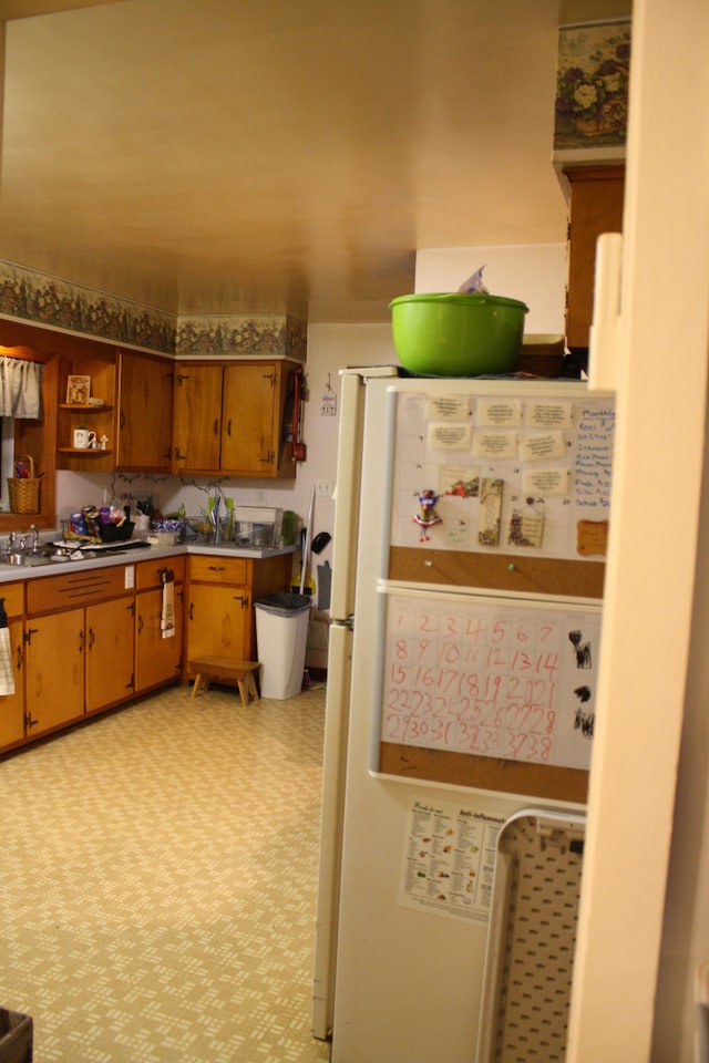 1 Elm Dr, Bethany, IL 61914 - kitchen featuring freestanding refrigerator, open shelves, light floors, brown cabinetry, and light countertops