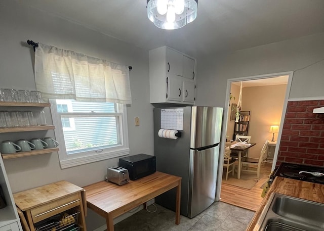 1302 Briarcliff Dr, Urbana, IL 61801 - kitchen featuring freestanding refrigerator, black microwave, stove, and light countertops