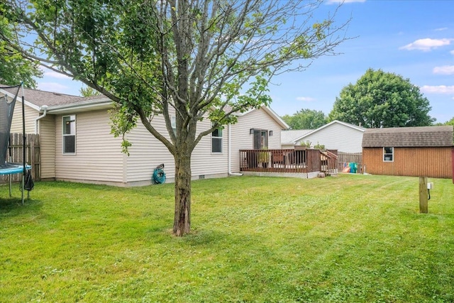 505 Tamula Dr, Mahomet, IL 61853 - view of yard featuring a trampoline, a deck, and an outbuilding