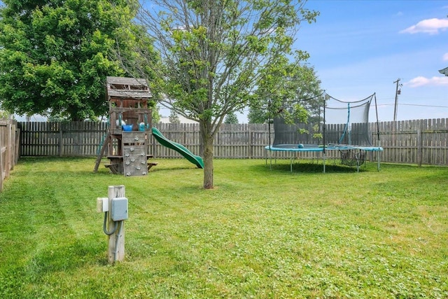 505 Tamula Dr, Mahomet, IL 61853 - fenced backyard featuring a trampoline and a playground