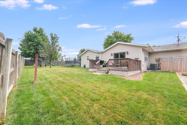 505 Tamula Dr, Mahomet, IL 61853 - fenced backyard featuring a trampoline, a playground, and a deck