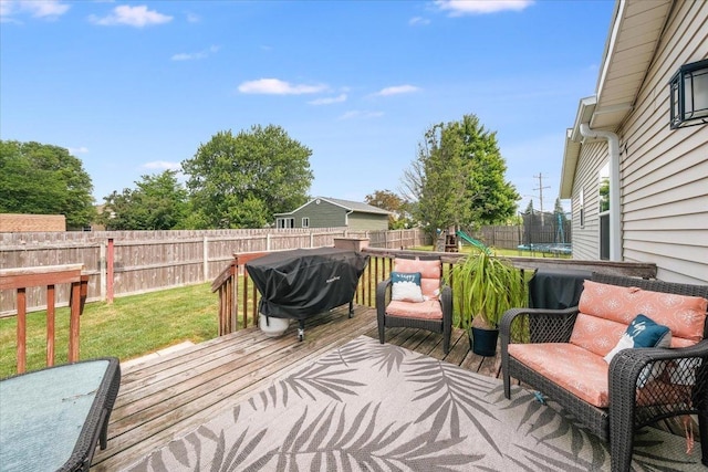 505 Tamula Dr, Mahomet, IL 61853 - wooden terrace with a trampoline, area for grilling, and a fenced backyard