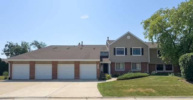 962 Harvest Cir, Buffalo Grove, IL 60089 - townhome / multi-family property with driveway, a front lawn, brick siding, and an attached garage