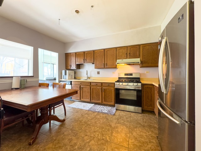 962 Harvest Cir, Buffalo Grove, IL 60089 - kitchen with appliances with stainless steel finishes, under cabinet range hood, light countertops, and brown cabinetry