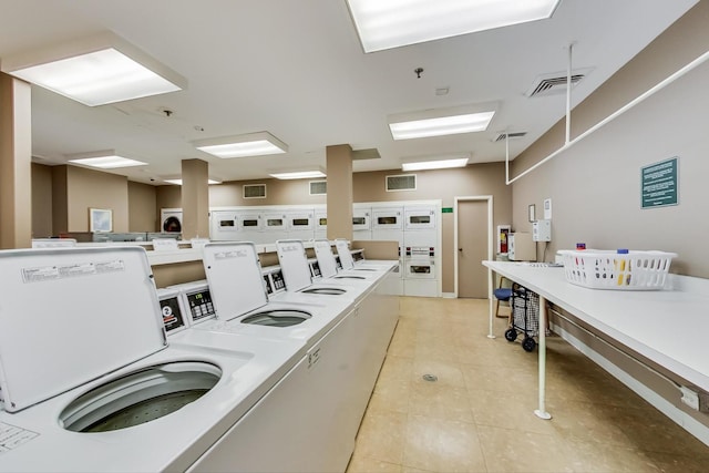 401 E Ontario St Unit 3008, Chicago, IL 60611 - community laundry room with washer and clothes dryer, light tile patterned floors, and stacked washer / drying machine