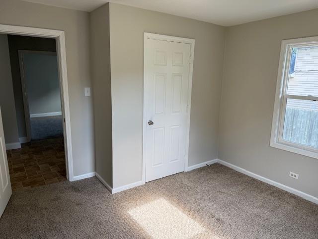 1023 N Elmwood Ave, Waukegan, IL 60085 - unfurnished bedroom with carpet and baseboards